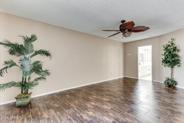 unfurnished room featuring a textured ceiling, dark hardwood / wood-style floors, and ceiling fan