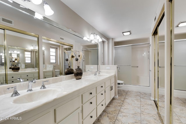 bathroom featuring vanity, a shower with shower door, toilet, and tile patterned flooring