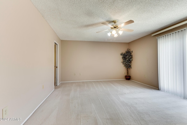 carpeted empty room with a textured ceiling and ceiling fan