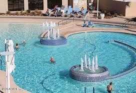 view of pool with a hot tub