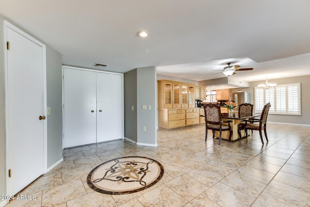 dining room with ceiling fan with notable chandelier