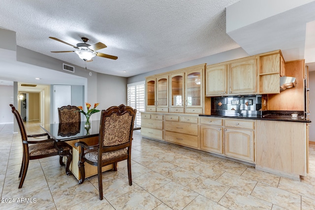 dining area featuring a textured ceiling and ceiling fan