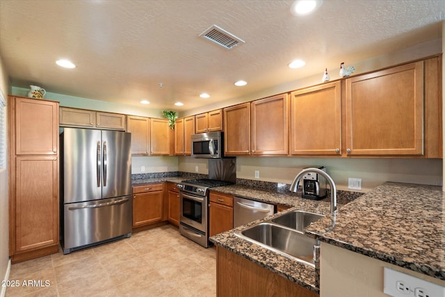 19700 N 76th St Unit 2089, Scottsdale, AZ 85255 - kitchen featuring visible vents, appliances with stainless steel finishes, dark stone countertops, and a sink