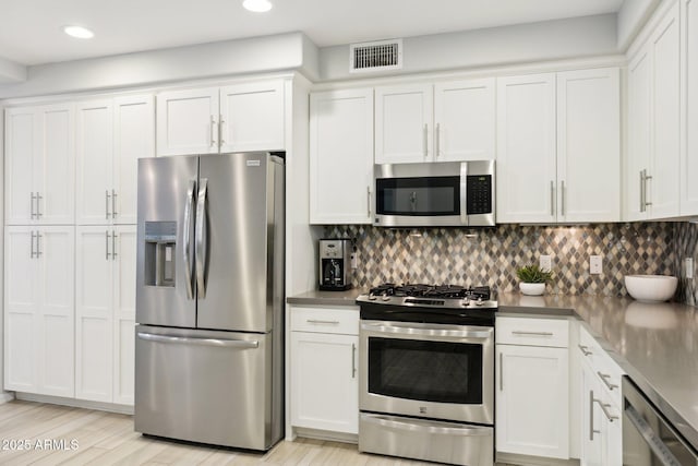 17850 N 68th St Unit 2138, Phoenix, AZ 85054 - kitchen with stainless steel appliances, white cabinetry, backsplash, recessed lighting, and light wood-style flooring