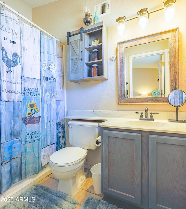 bathroom featuring a shower with curtain, tile patterned floors, vanity, and toilet