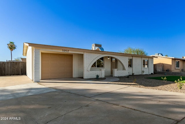 ranch-style home featuring a garage