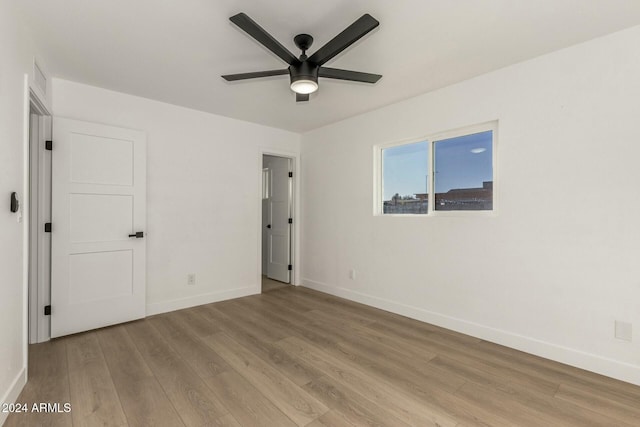 unfurnished bedroom with ceiling fan and light hardwood / wood-style flooring