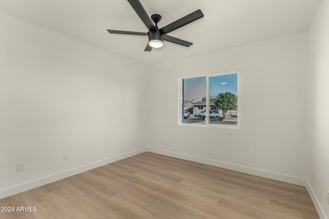 spare room with ceiling fan and light wood-type flooring