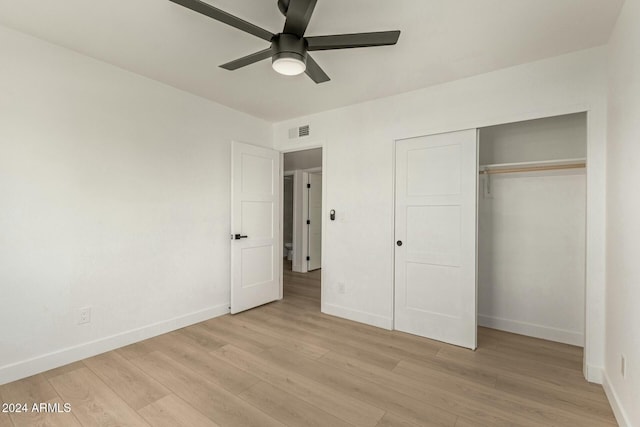 unfurnished bedroom with ceiling fan, a closet, and light hardwood / wood-style floors