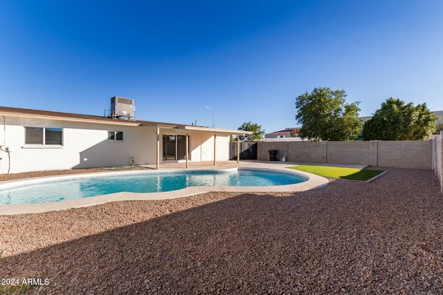 view of pool with cooling unit and a patio area