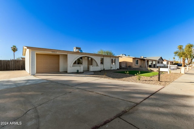 ranch-style house featuring a garage