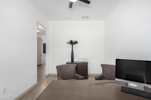 living room featuring ceiling fan and light wood-type flooring