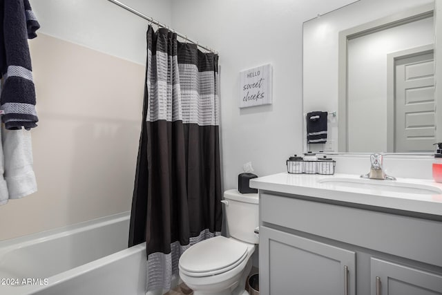 full bathroom featuring large vanity, toilet, and shower / tub combo with curtain