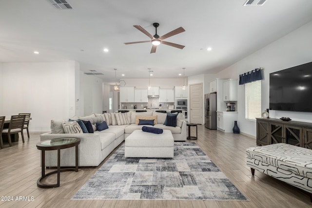 living room with light wood-type flooring and ceiling fan