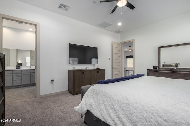 bedroom with connected bathroom, carpet floors, and ceiling fan