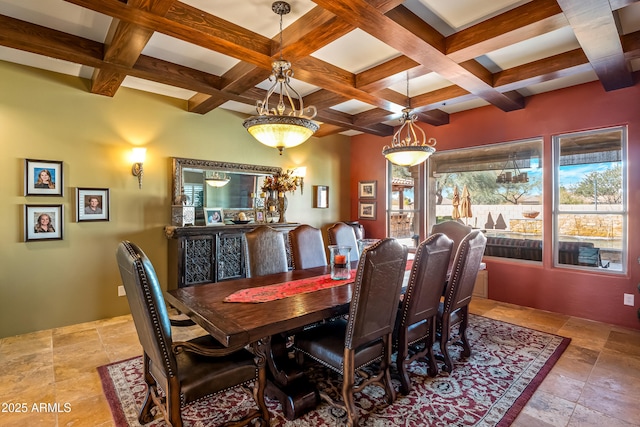 dining room with stone finish flooring, coffered ceiling, and beam ceiling