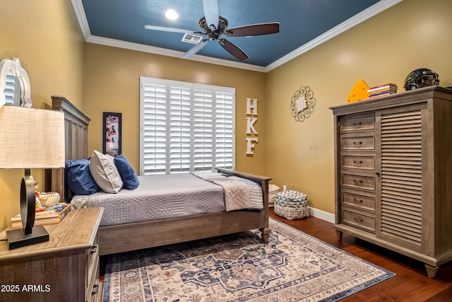 bedroom featuring baseboards, visible vents, a ceiling fan, dark wood-style flooring, and crown molding