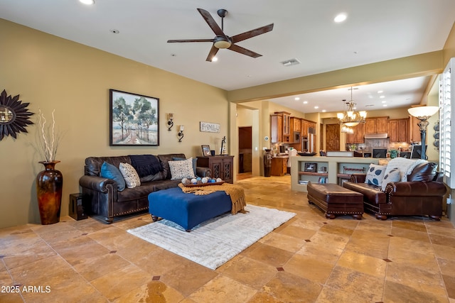 living room with ceiling fan with notable chandelier, visible vents, and recessed lighting