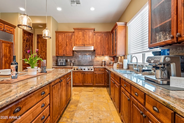 kitchen with stainless steel gas cooktop, visible vents, backsplash, glass insert cabinets, and a sink