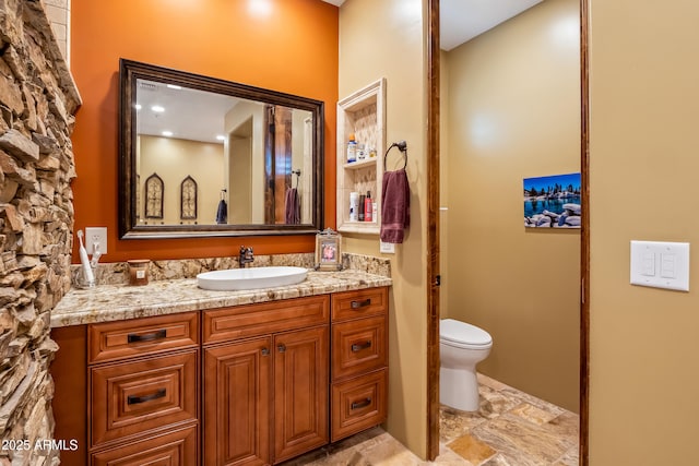 bathroom with toilet and vanity