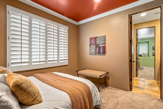 bedroom with visible vents, a textured wall, light colored carpet, and crown molding