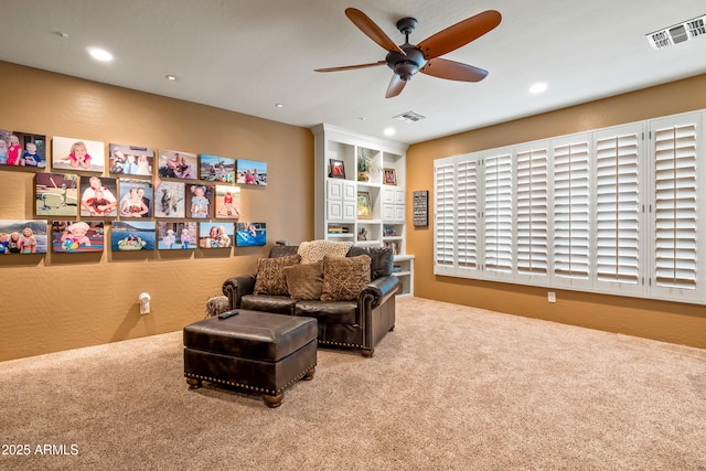 sitting room with recessed lighting, visible vents, and carpet