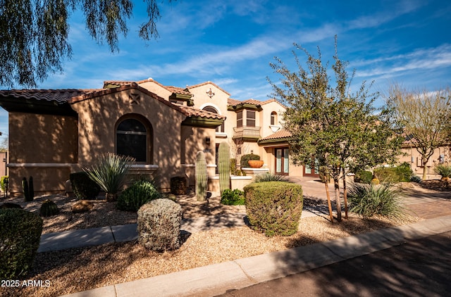 mediterranean / spanish-style house with a tiled roof and stucco siding