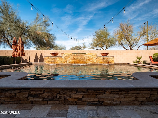 view of swimming pool featuring a fenced backyard and a fenced in pool