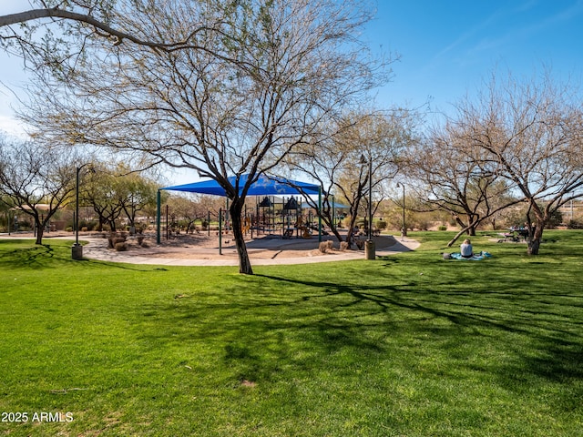 view of home's community with playground community and a yard