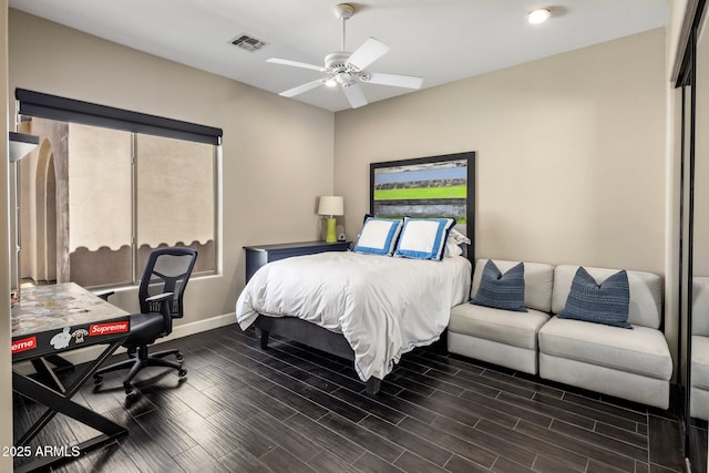 bedroom with wood finish floors, visible vents, ceiling fan, and baseboards