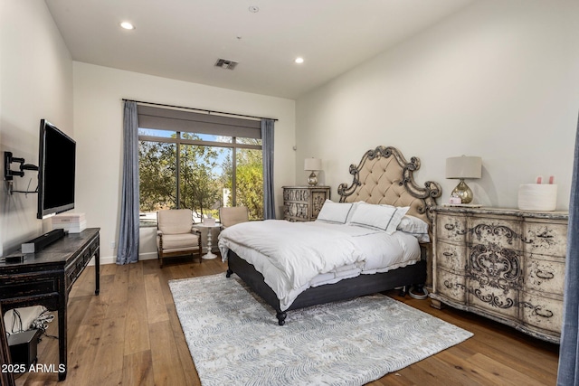 bedroom featuring hardwood / wood-style floors, visible vents, and recessed lighting