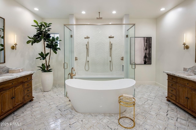 full bath with recessed lighting, vanity, baseboards, a soaking tub, and a stall shower