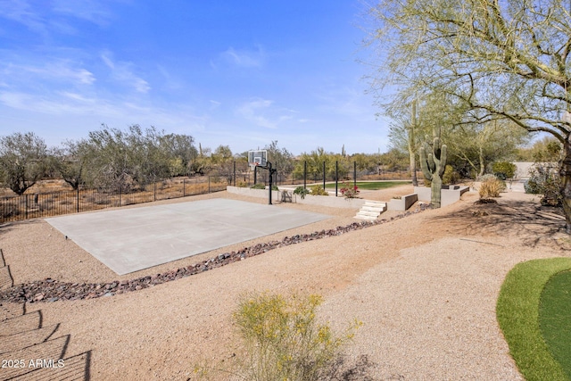 view of basketball court featuring community basketball court and fence