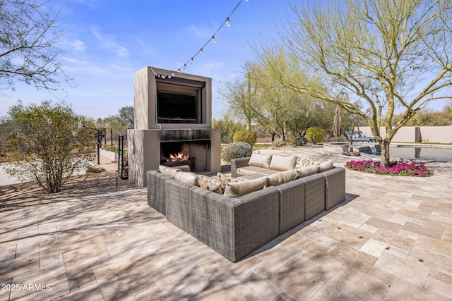 exterior space featuring a warm lit fireplace