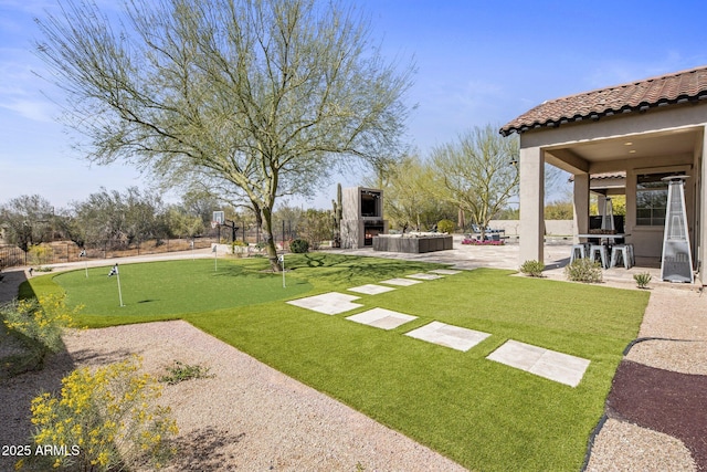 view of yard with a patio and exterior fireplace