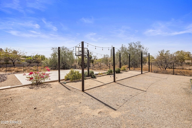 view of basketball court with fence