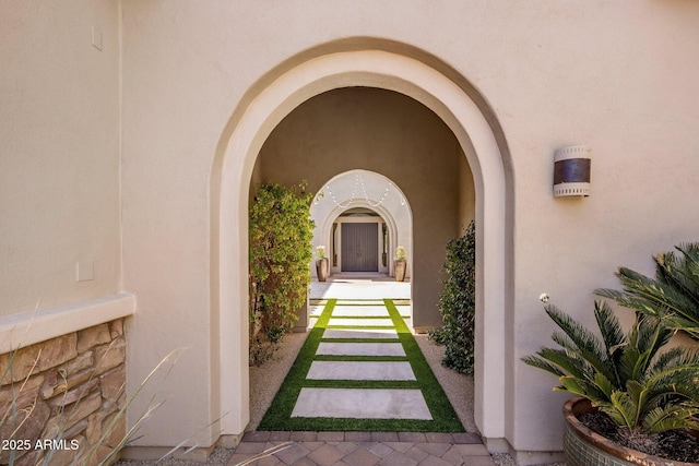 view of exterior entry featuring stucco siding