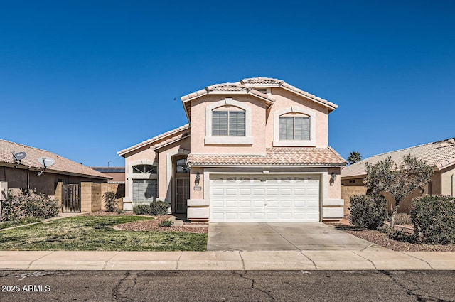 mediterranean / spanish house featuring driveway, an attached garage, a tile roof, and stucco siding