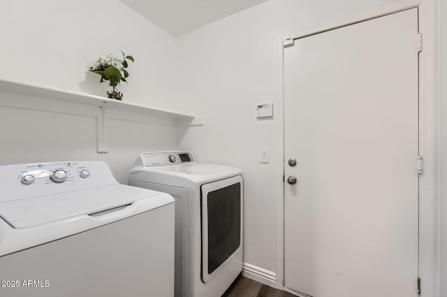 laundry area with dark wood-style floors, laundry area, and washing machine and clothes dryer