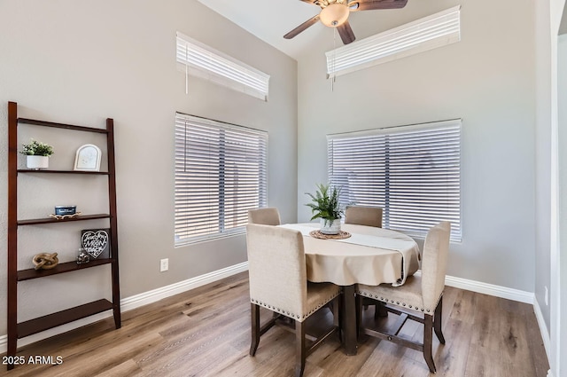 dining area featuring ceiling fan, wood finished floors, and baseboards