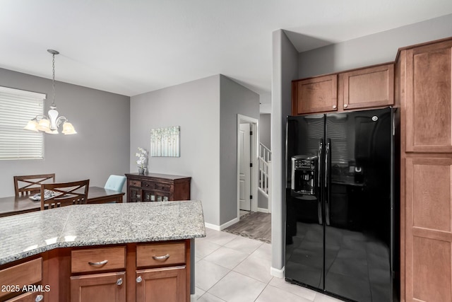 4043 E Carla Vista Dr, Gilbert, AZ 85295 - kitchen with black fridge, a chandelier, hanging light fixtures, and brown cabinetry