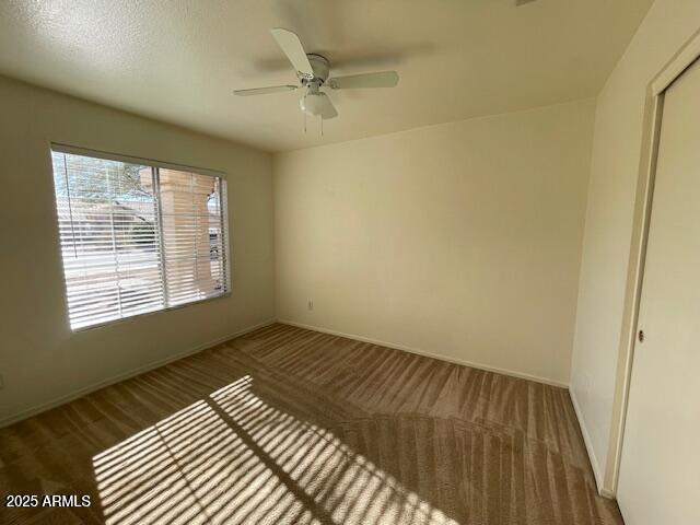 unfurnished room with ceiling fan