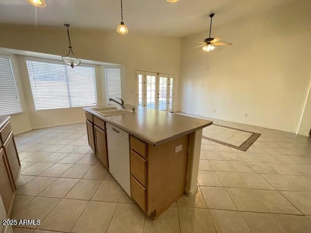 kitchen with sink, hanging light fixtures, white dishwasher, a center island with sink, and french doors