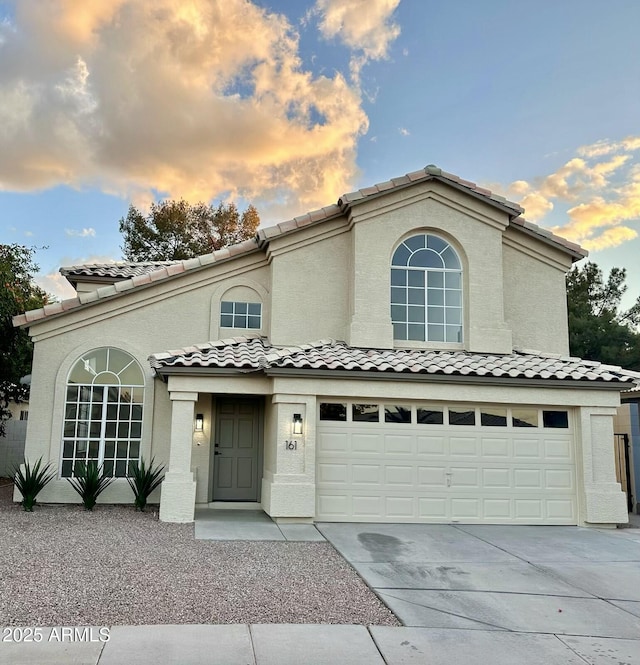 mediterranean / spanish-style home featuring a garage