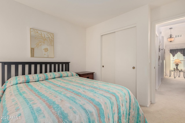 carpeted bedroom featuring a closet