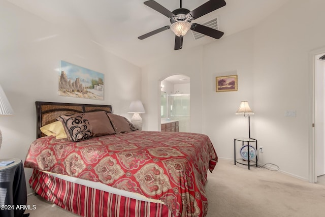 carpeted bedroom with ensuite bathroom and ceiling fan