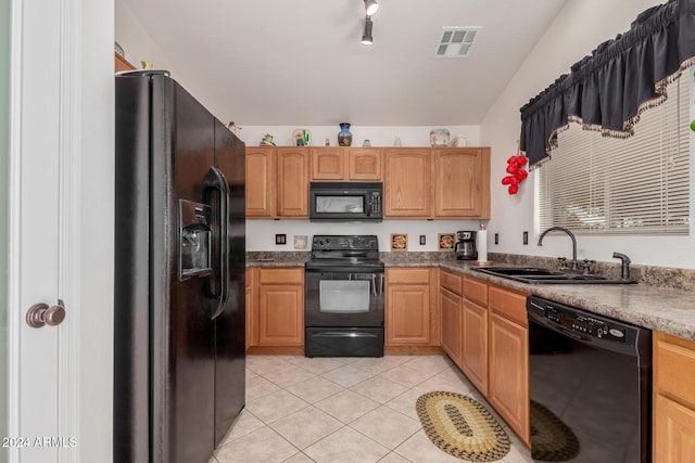 kitchen featuring light tile patterned floors, sink, lofted ceiling, and black appliances