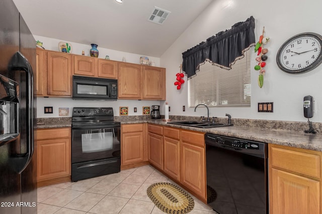 kitchen with black appliances, light tile patterned flooring, sink, and vaulted ceiling