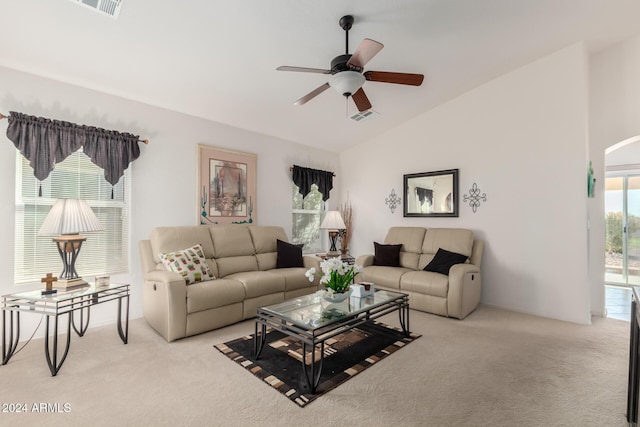 living room featuring light carpet, ceiling fan, and vaulted ceiling