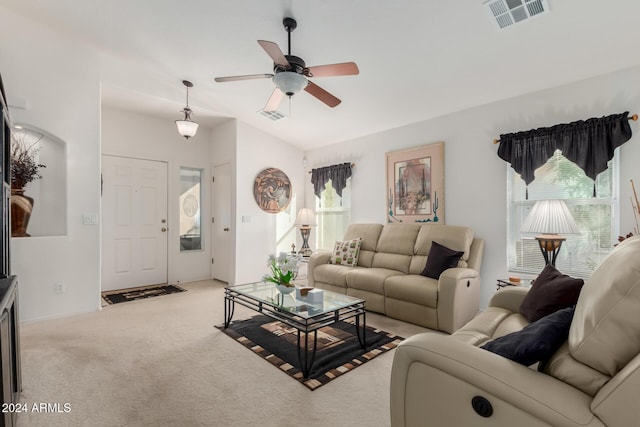 living room with light carpet, vaulted ceiling, plenty of natural light, and ceiling fan